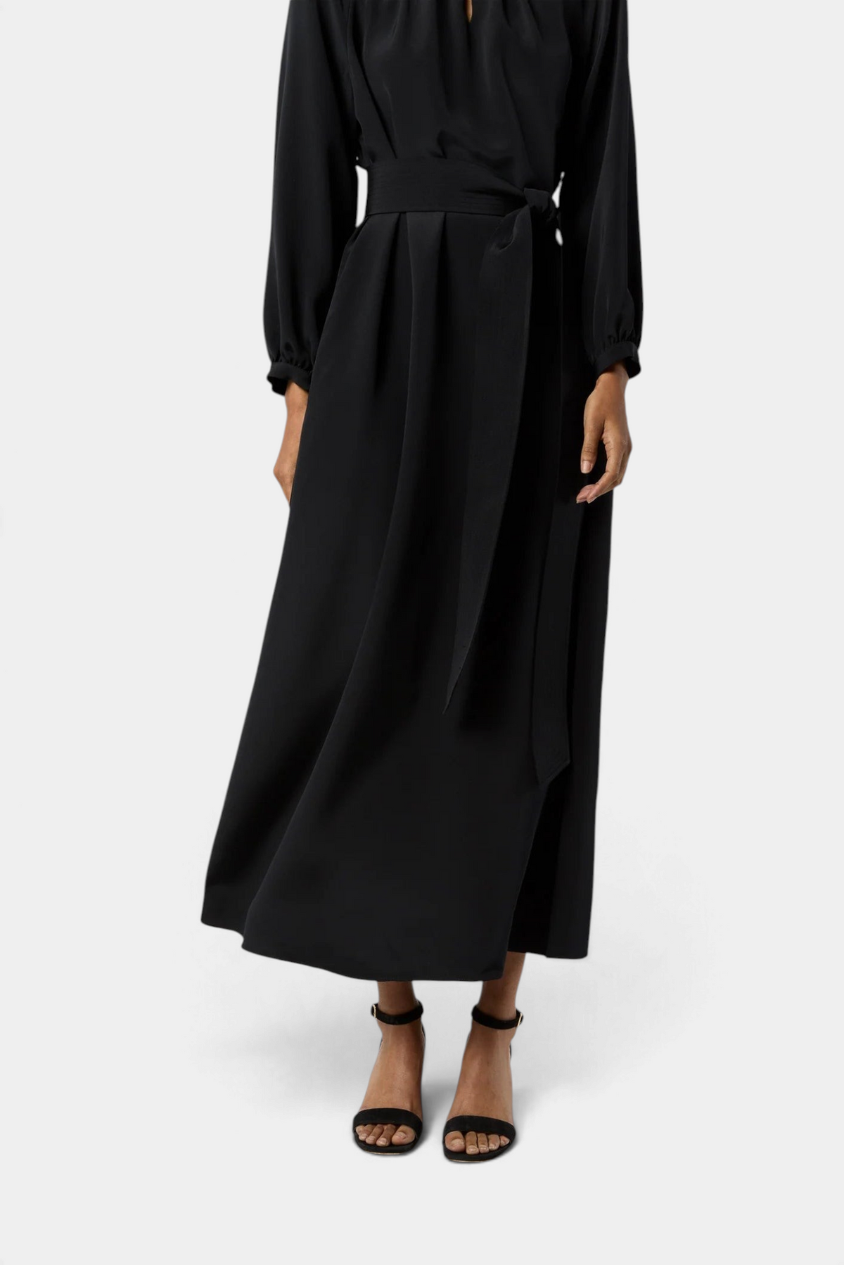 The Copper Shed Ariana maxi dress in black crepe de chine with long sleeves and a tie waist belt.