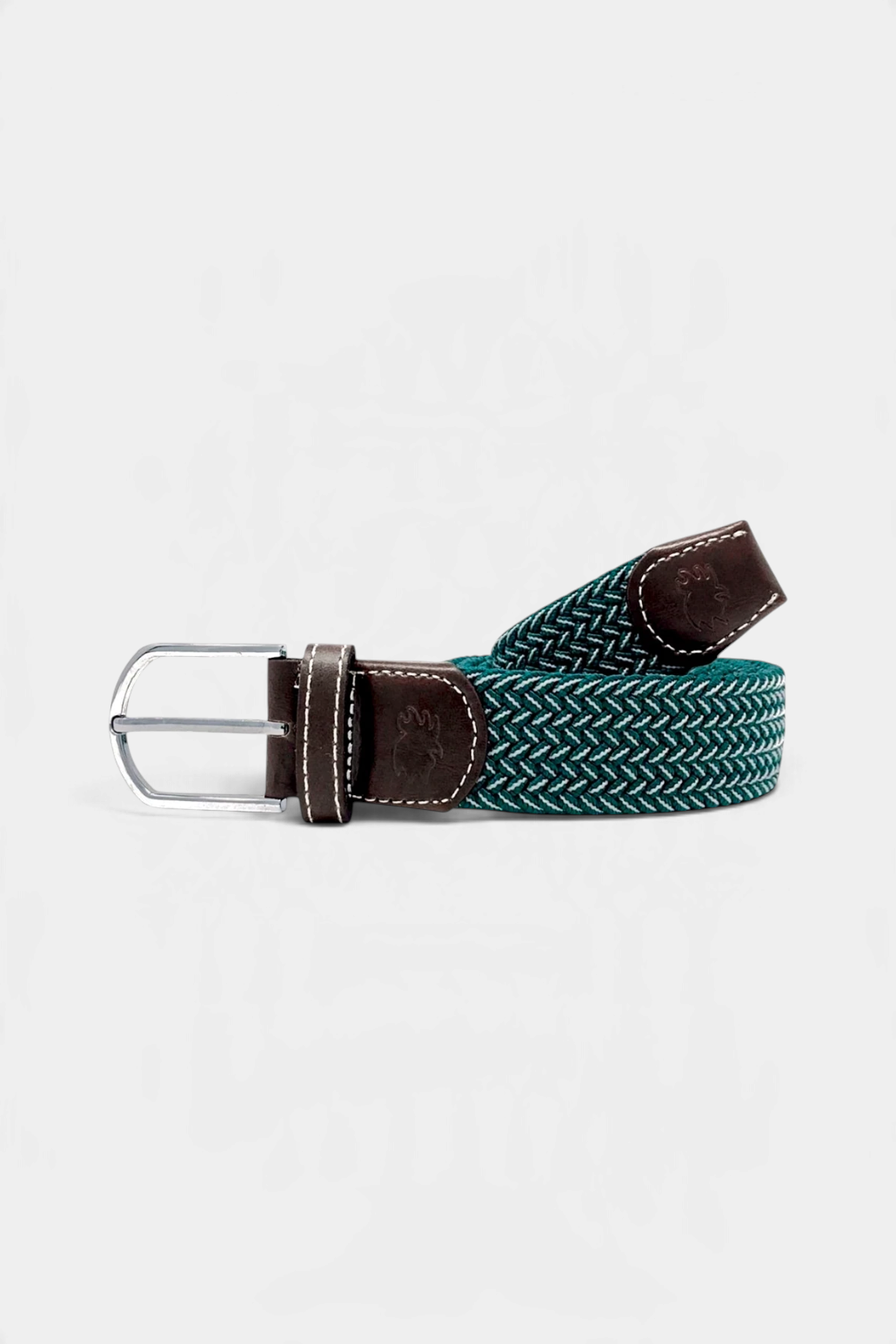 The Copper Shed Bandon green and white woven stretch belt with dark brown leather accents and a silver buckle.