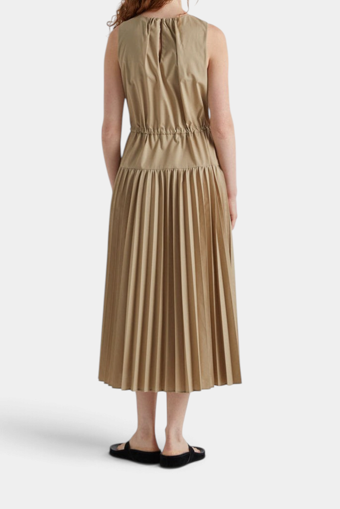 The Copper Shed long beige sleeveless dress with a drawstring waist, pleated skirt, and back teardrop closure.
