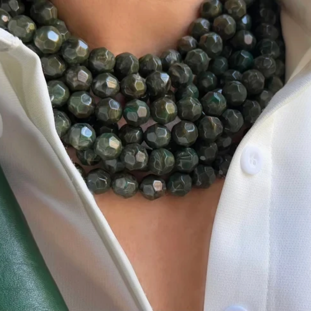 The Copper Shed Bella Marble Olive necklace featuring layered faceted dark green resin beads on a leather collar