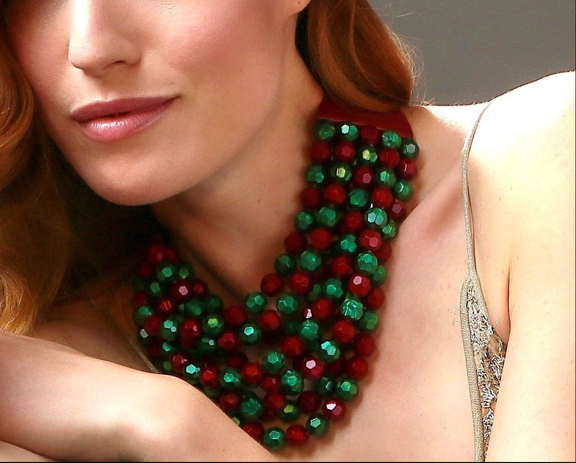 The Copper Shed Bella novelty necklace featuring layered red and green resin beads on a leather collar.