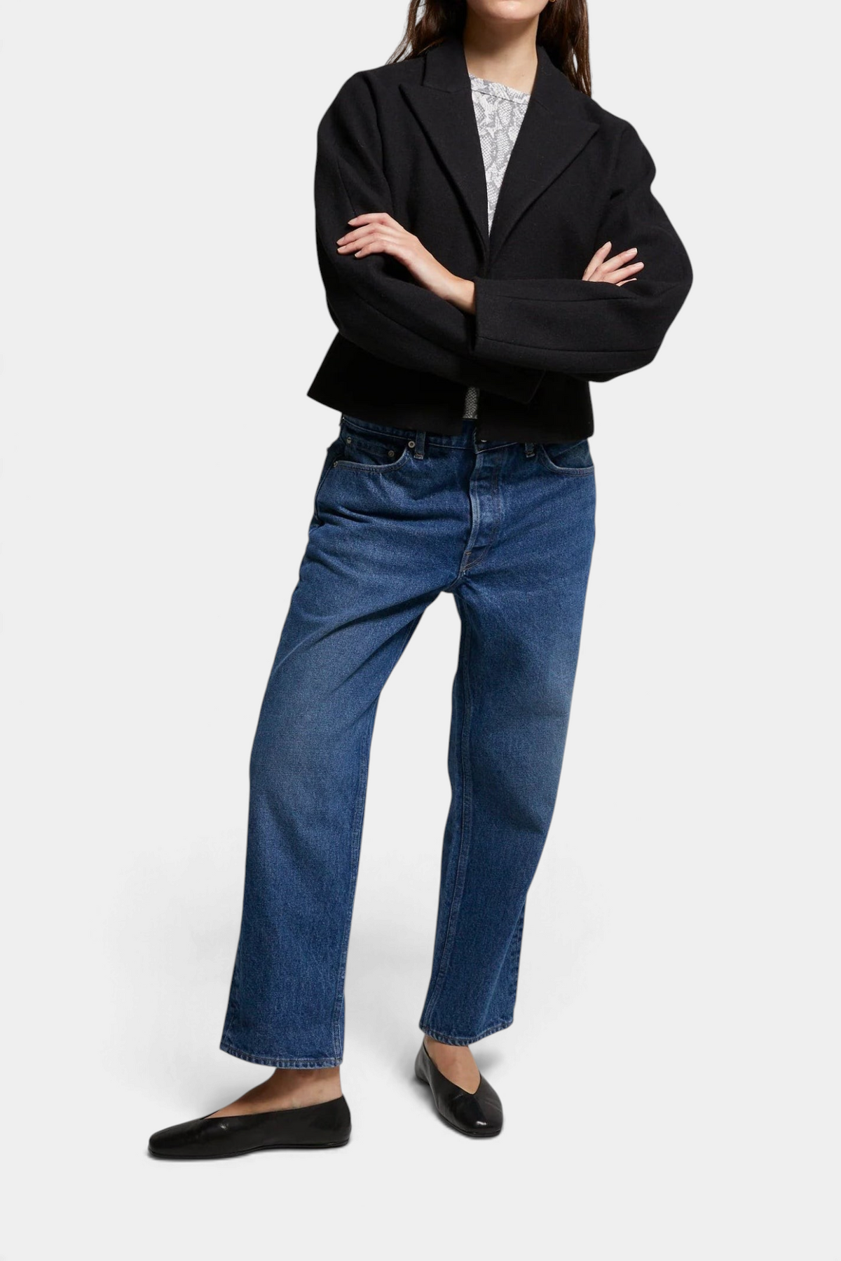 The Copper Shed Bethany blazer in black brushed felt with a cinched waist, worn with blue denim jeans.