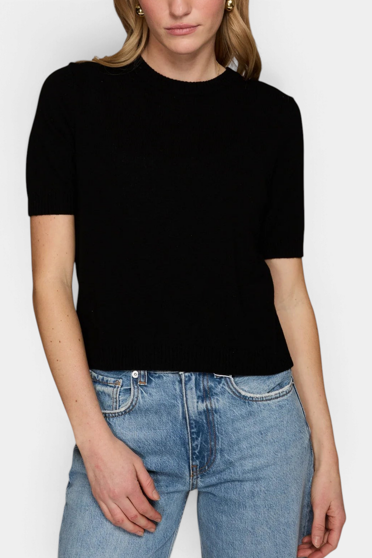 The Copper Shed Autum Cashmere black short-sleeve cropped crew neck sweater with ribbed trims worn with blue jeans