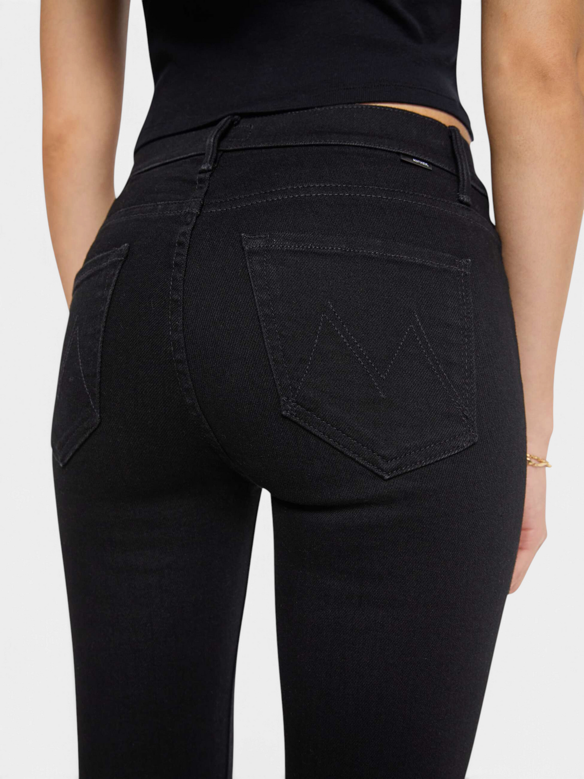 The Copper Shed The Weekender mid-rise black flare jeans with a clean hem viewed from the back
