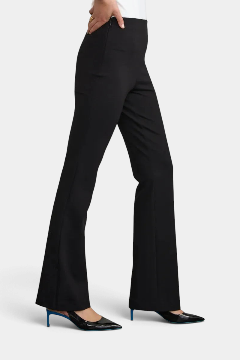The Copper Shed black flared ponte pants with a side zipper, worn by a model with black pointed heels.