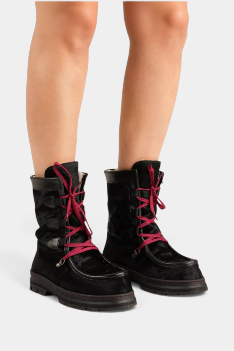 The Copper Shed Intrepid Pony Boot in black cowhide with red laces, shearling lining, and a sturdy rubber sole.