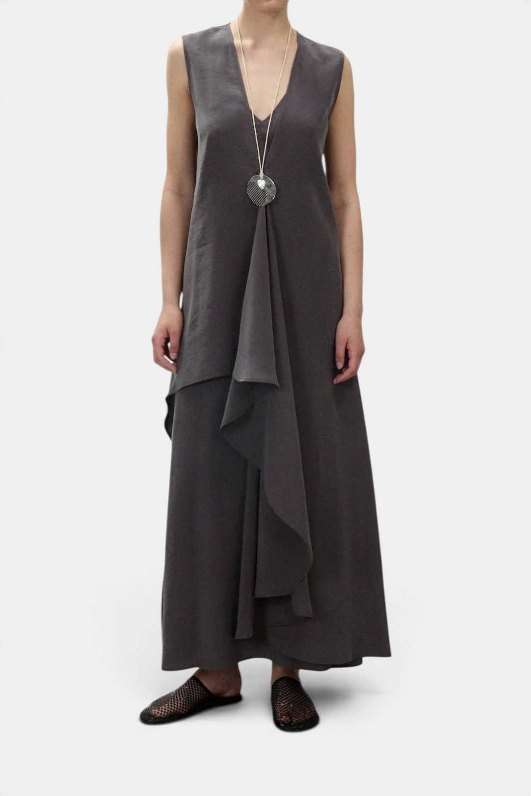 The Copper Shed sleeveless black maxi dress with V-neck, flared silhouette, and cascading ruffle detail.