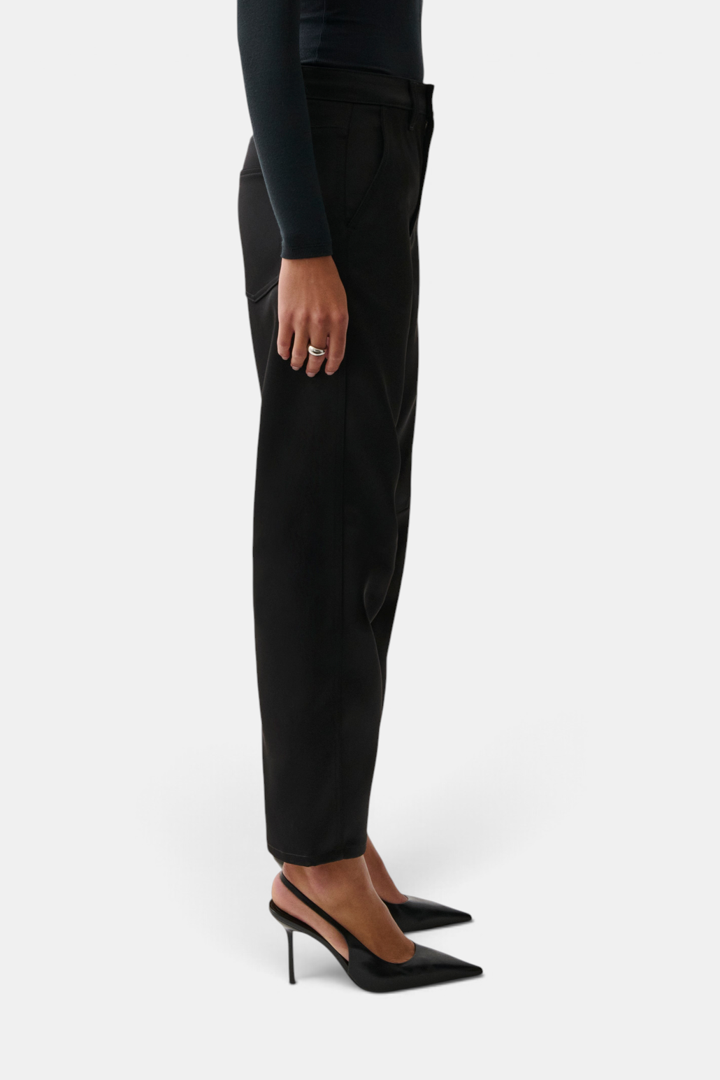The Copper Shed Beau black sateen trousers with seamed crescent leg detail, shown from a side profile view.