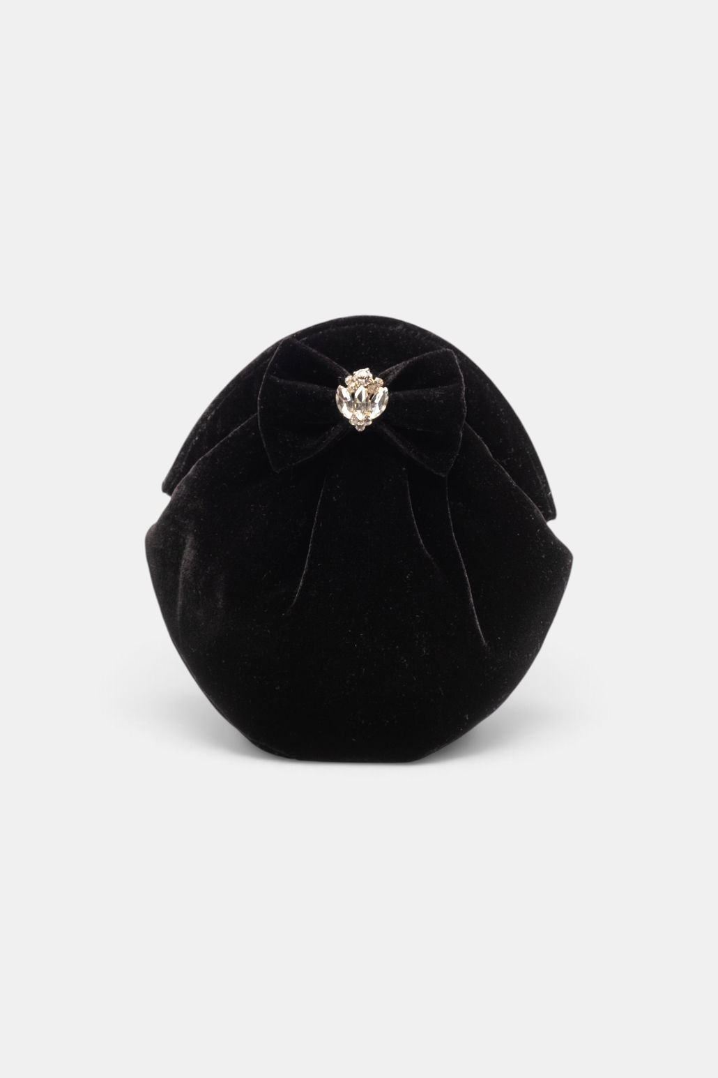 The Copper Shed black velvet oval clutch featuring a decorative bow with a crystal accent and magnetic snap closure.