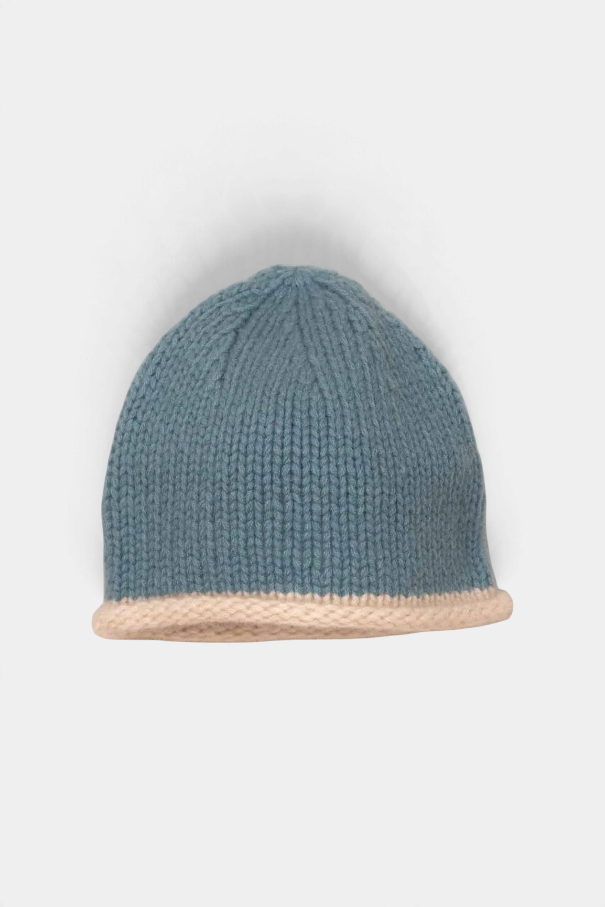 The Copper Shed blue organic cashmere beanie with a chunky hand-knitted texture and a contrasting cream rolled edge.