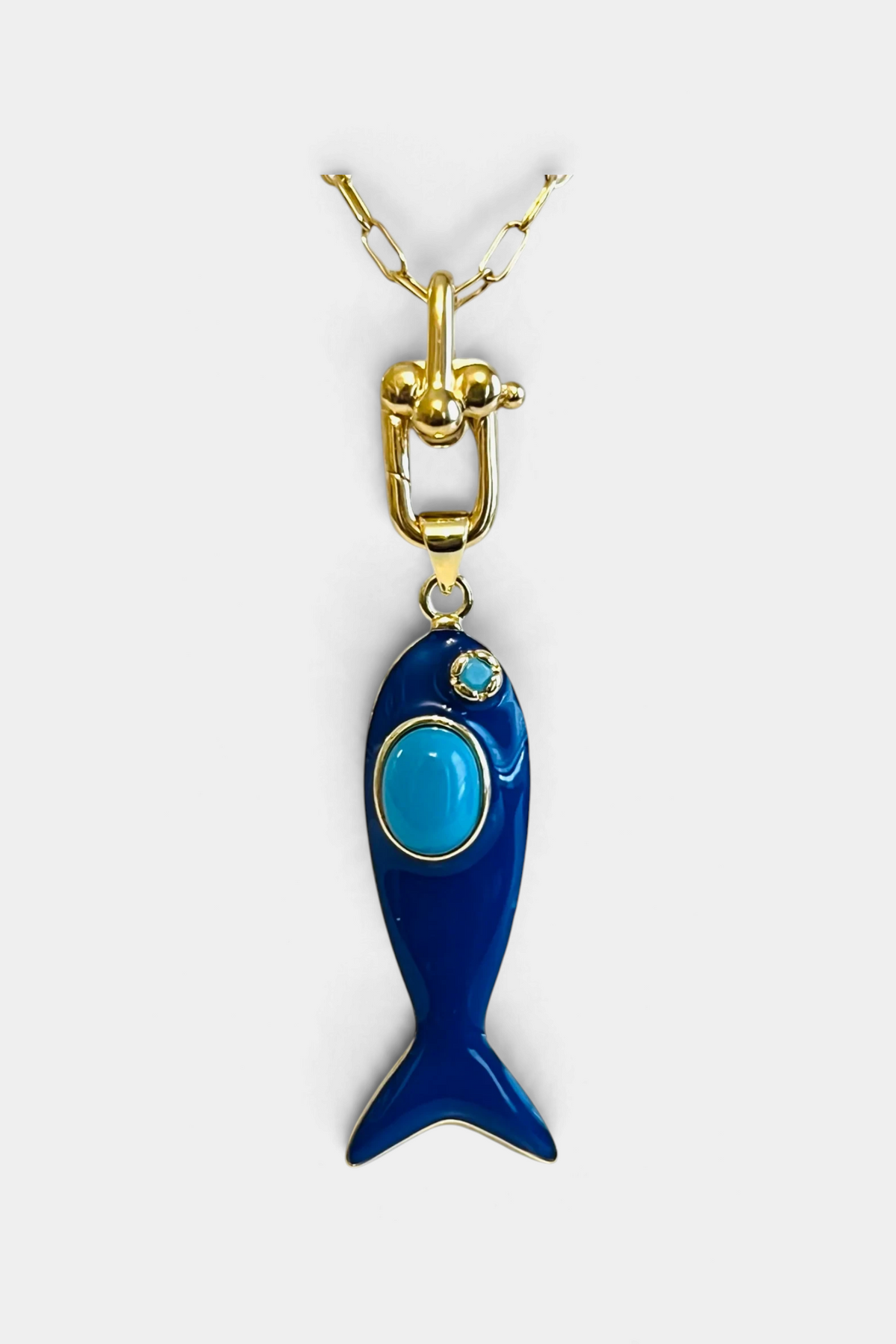 The Copper Shed Go Fish enamel pendant in dark blue with a turquoise stone on a 14k gold filled paperclip chain