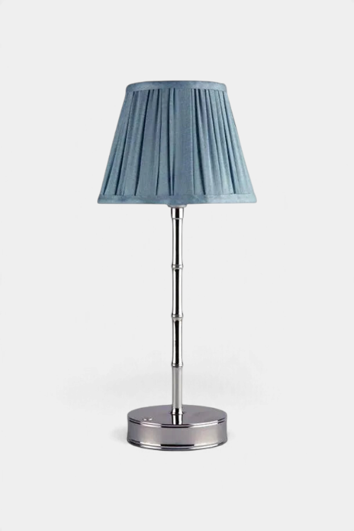 The Copper Shed blue pleated scalloped lampshade on a silver metal bamboo-style lamp base against a white background.