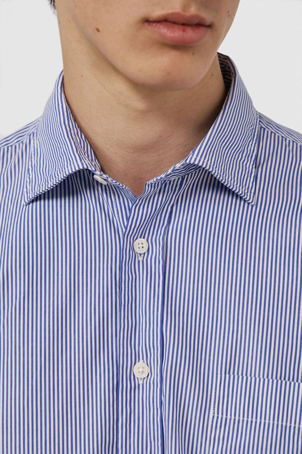 The Copper Shed blue and white striped cotton poplin shirt with a semi-spread collar and button-front closure.