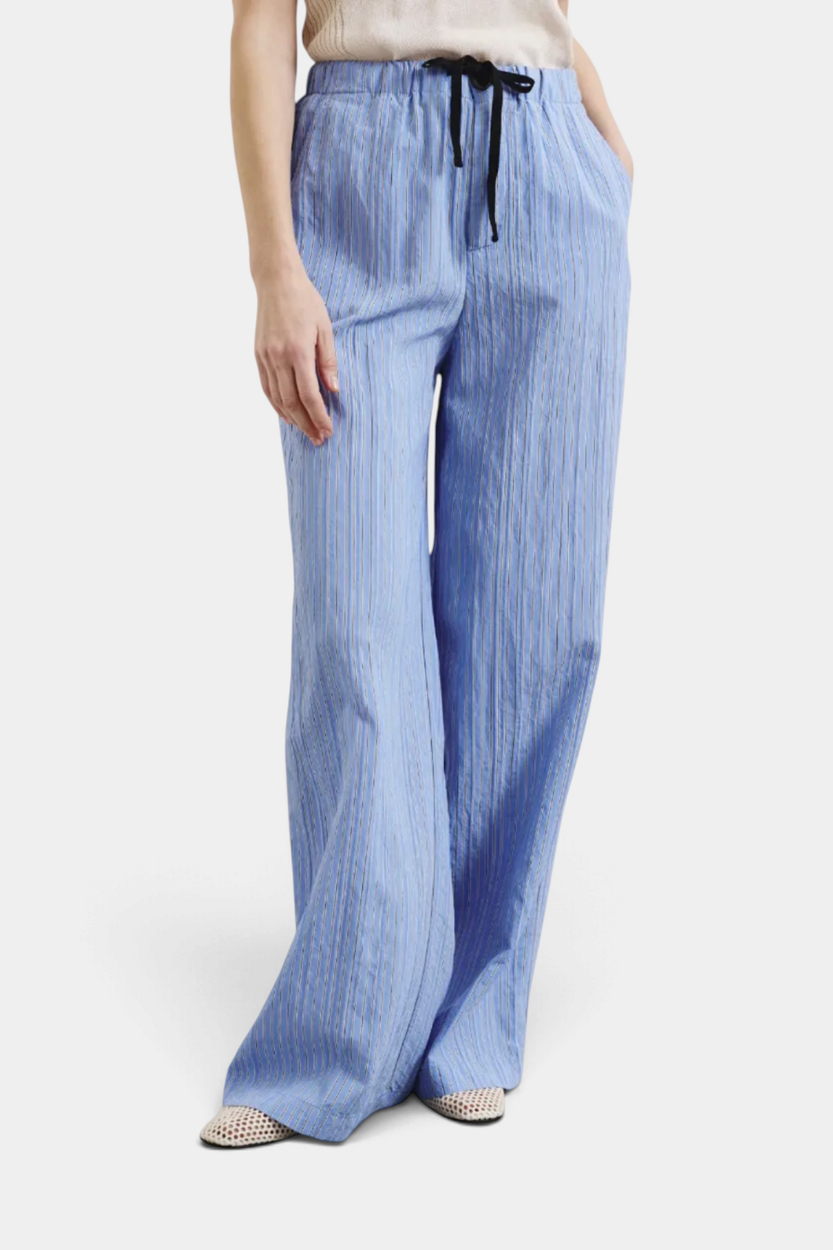 The Copper Shed blue striped technical viscose trousers with a relaxed pull-up fit and black drawstring waist.