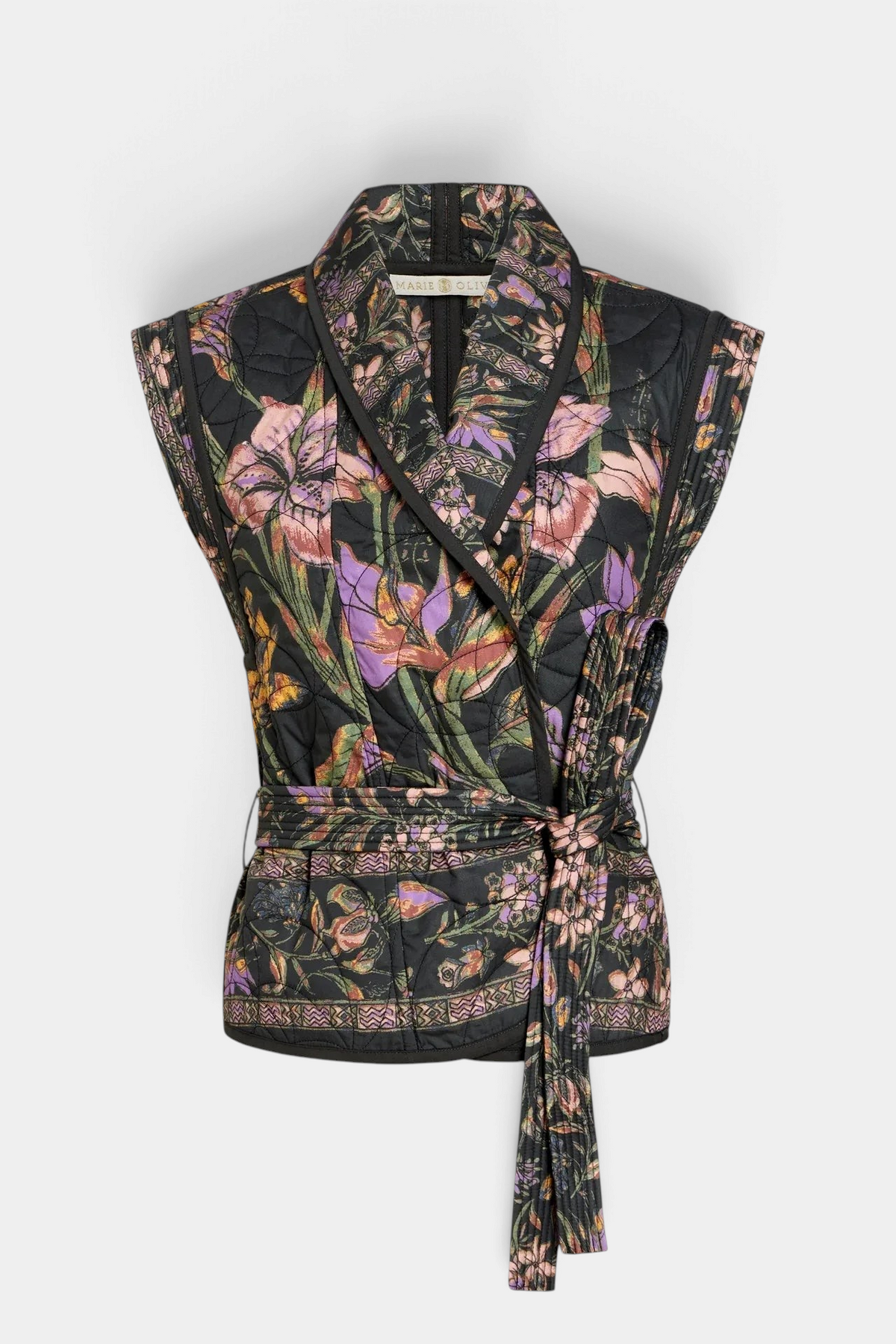 The Copper Shed Bowie vest in black floral quilted cotton with a shawl collar and wrap-around tie belt.