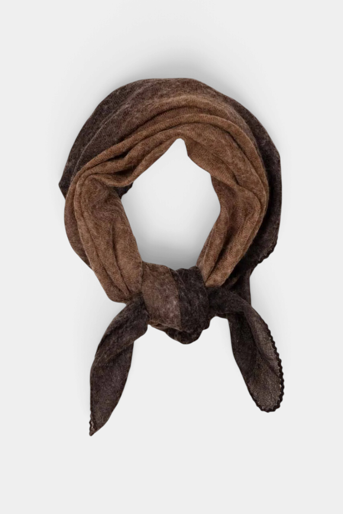 The Copper Shed Muse cashmere foulard in brown tones with a hand-stitched edge, tied in a knot.