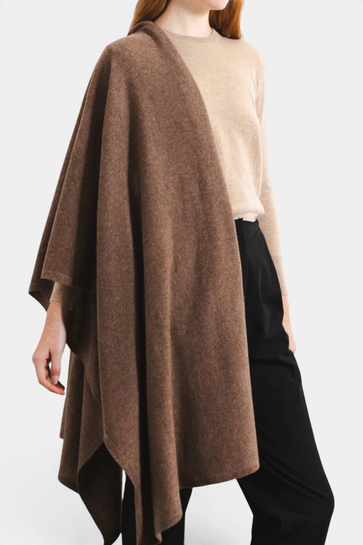 The Copper Shed oversized brown cashmere travel wrap draped elegantly over a model wearing a beige sweater.
