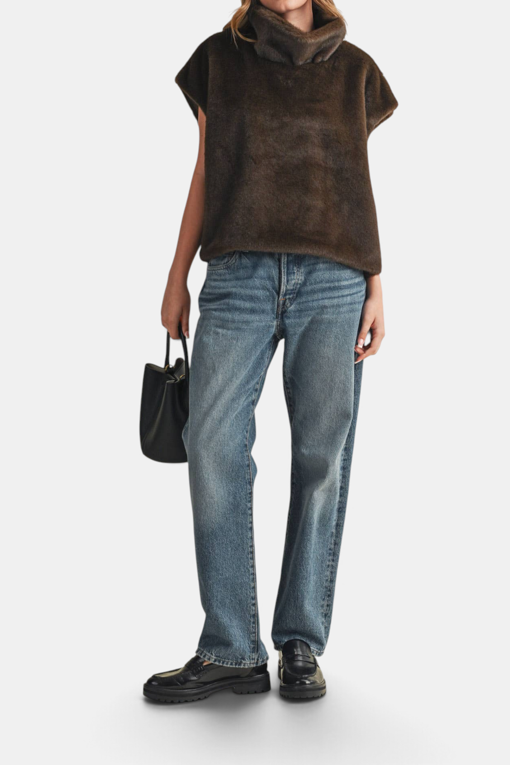 The Copper Shed brown faux fur cap sleeve turtleneck top with a relaxed fit worn with blue jeans and loafers.
