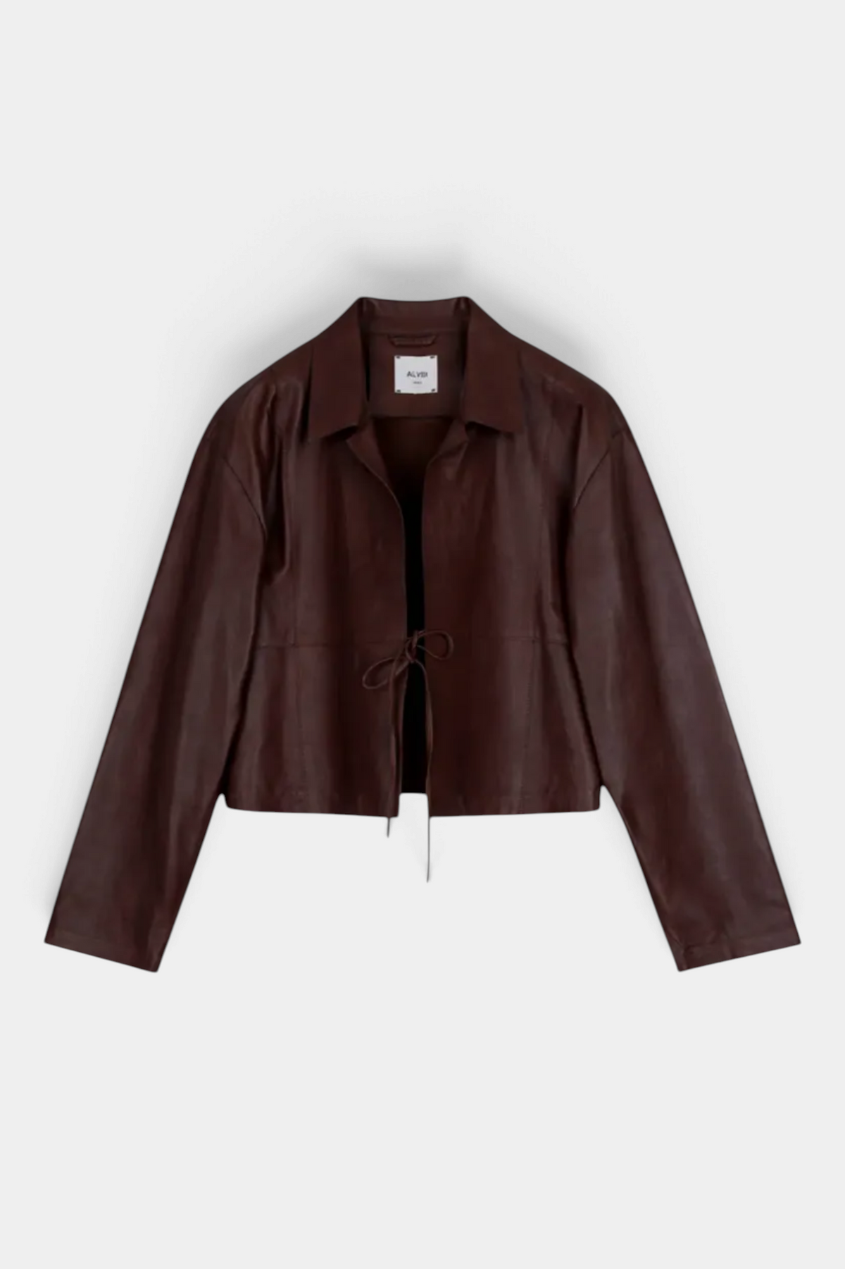 The Copper Shed short brown genuine leather jacket with a classic collar, flared sleeves, and front drawstring tie.