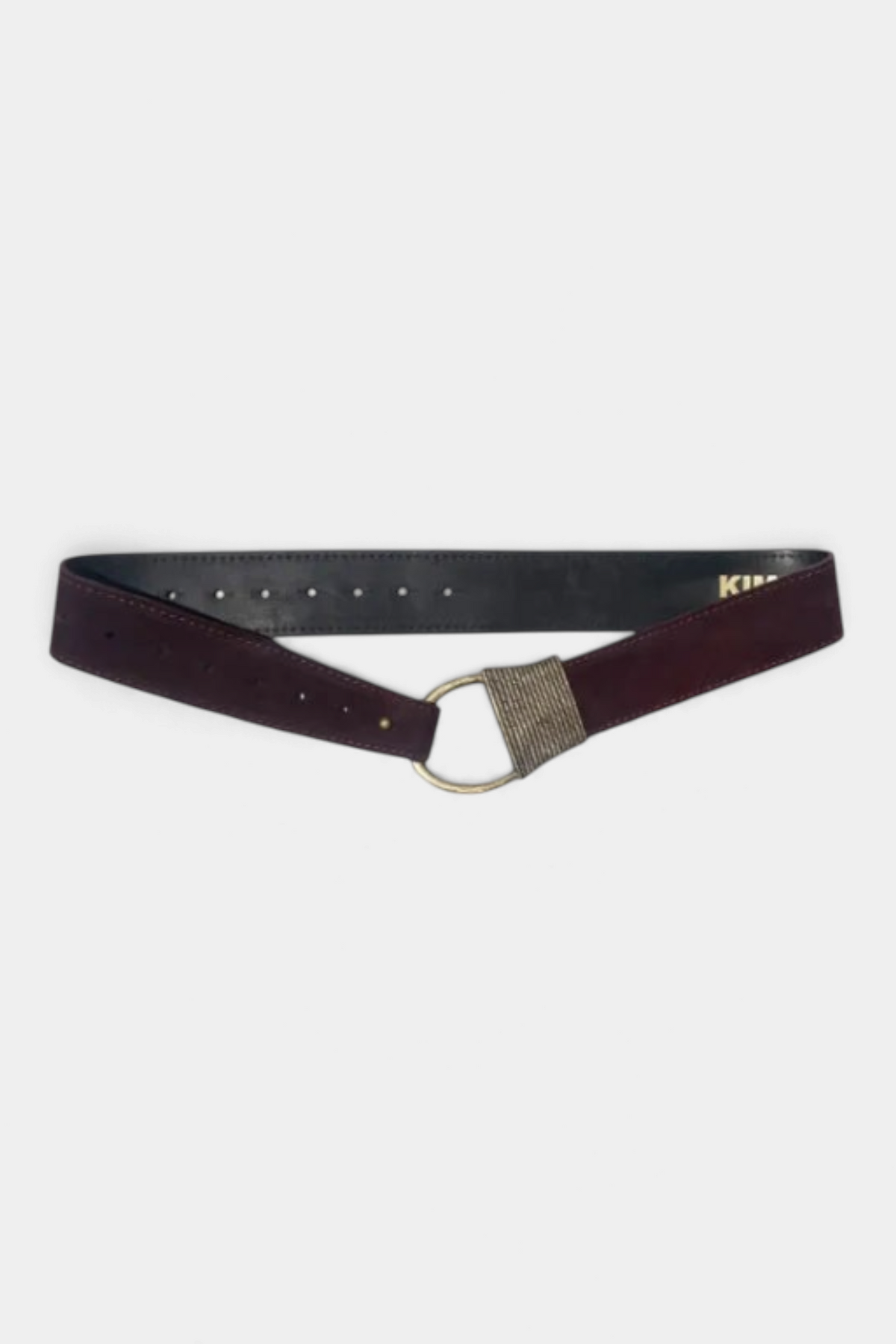 The Copper Shed Cast Rope Belt in dark burgundy suede with a metallic ring buckle and adjustable hole detailing.
