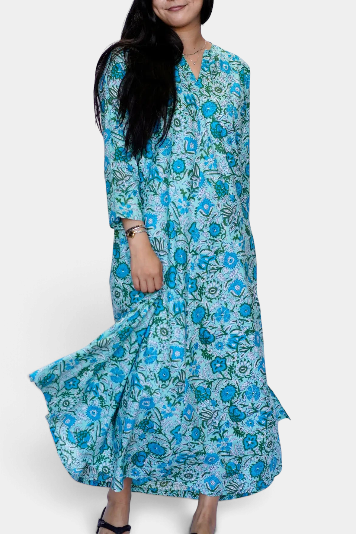The Copper Shed Calypso dress in turquoise and sage floral cotton with a-line silhouette, pockets, and side slit.