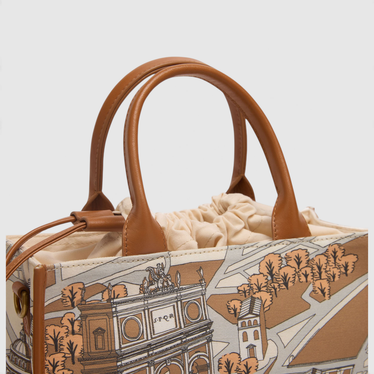 The Copper Shed Caprice Bag in Rome print with cotton body and brown leather handles on a neutral background
