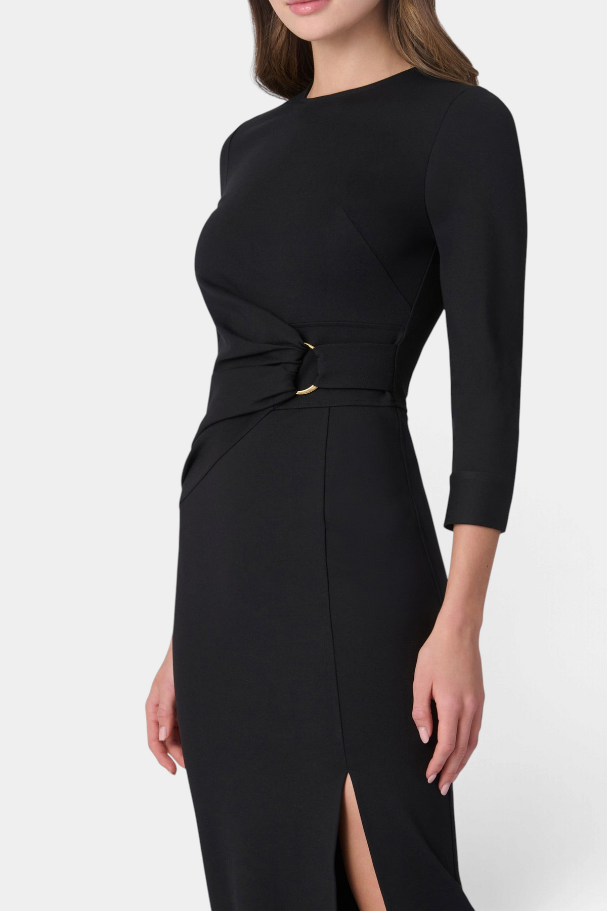 The Copper Shed Cara midi dress in black with three-quarter sleeves, waist draping, gold ring detail, and front slit.