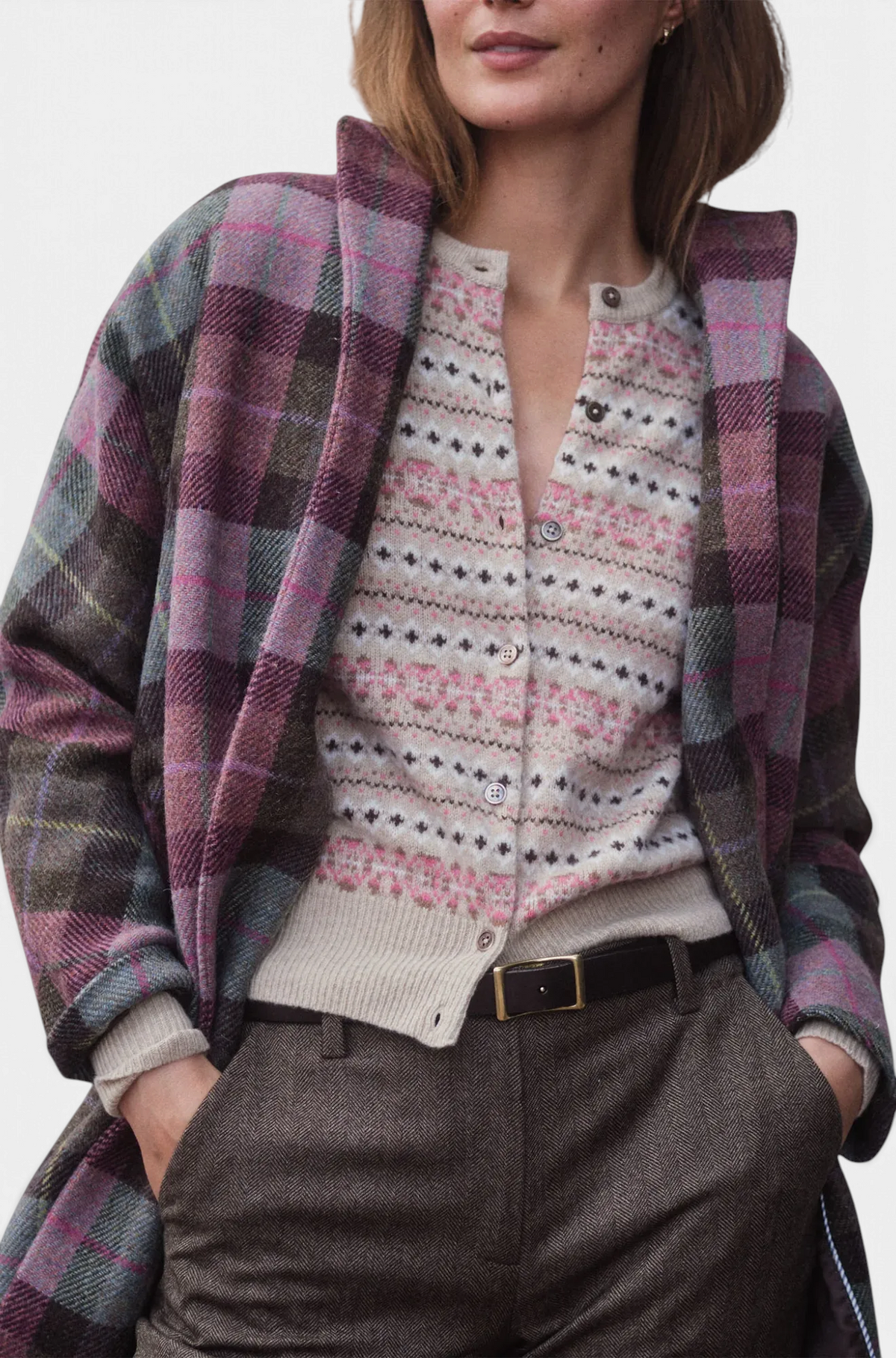 The Copper Shed Kimono Carina Coat in purple and green plaid Harris Tweed worn over a patterned cardigan