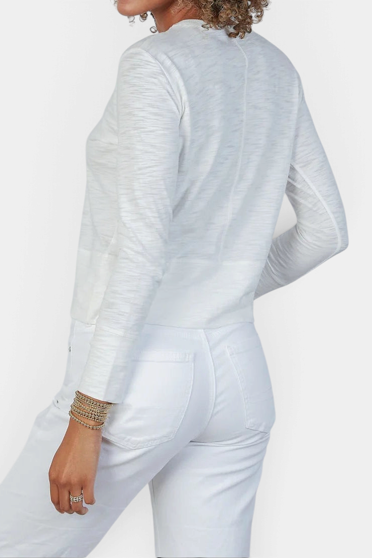 The Copper Shed Celia white long sleeve Pima cotton slub tee with double-layered cuffs, worn with white jeans.