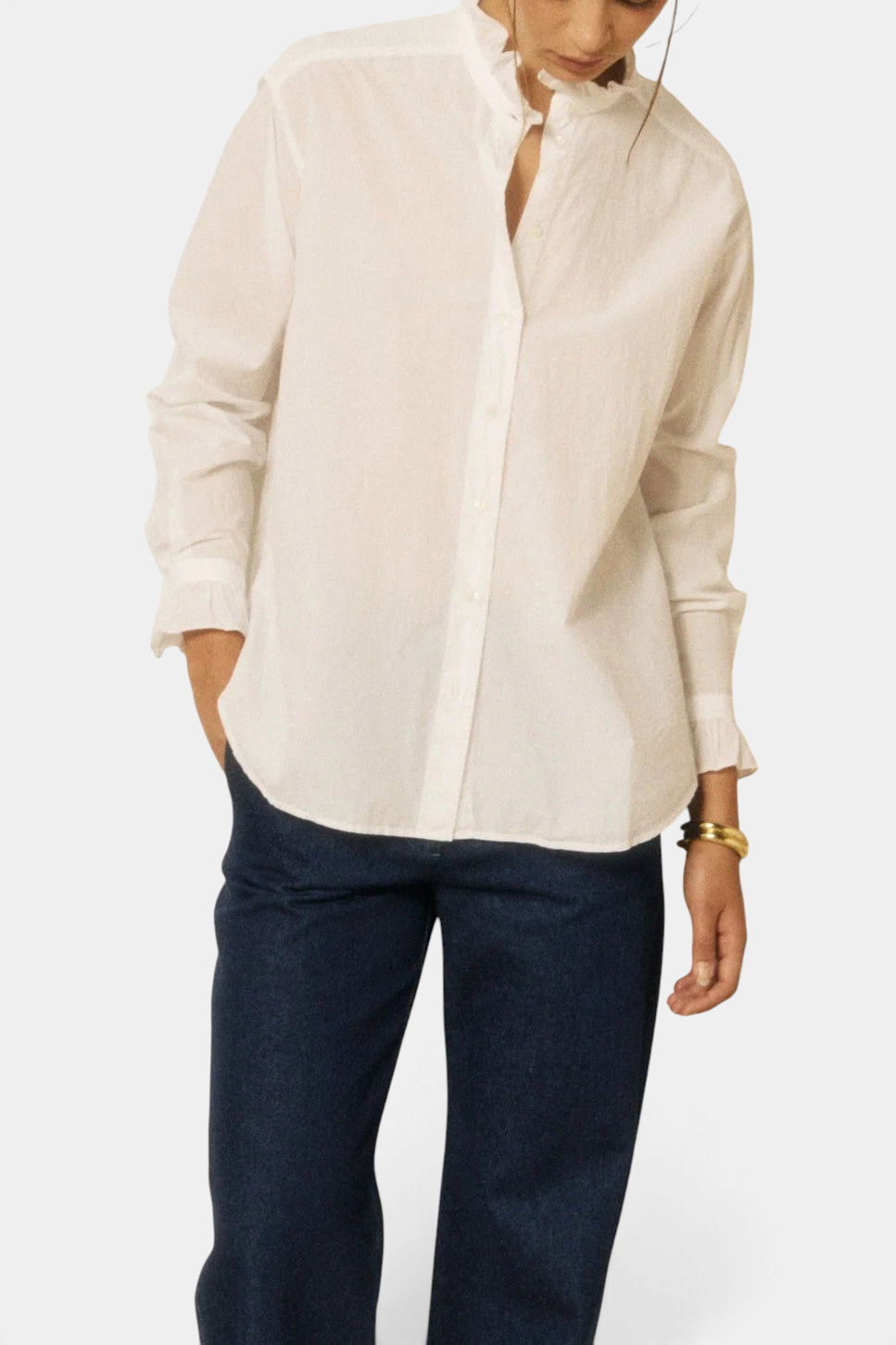 The Copper Shed Chana white cotton poplin shirt with ruffled collar and cuffs worn with dark blue jeans