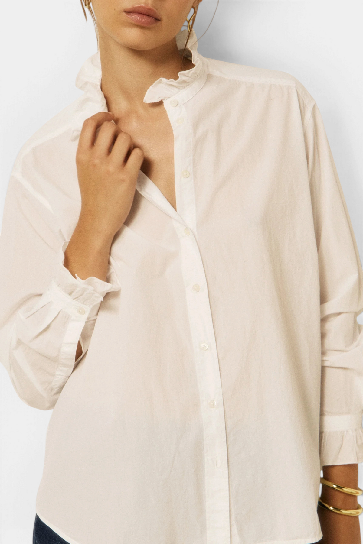 The Copper Shed Chana white cotton poplin shirt featuring a ruffled stand-up collar and gathered cuffs on a model