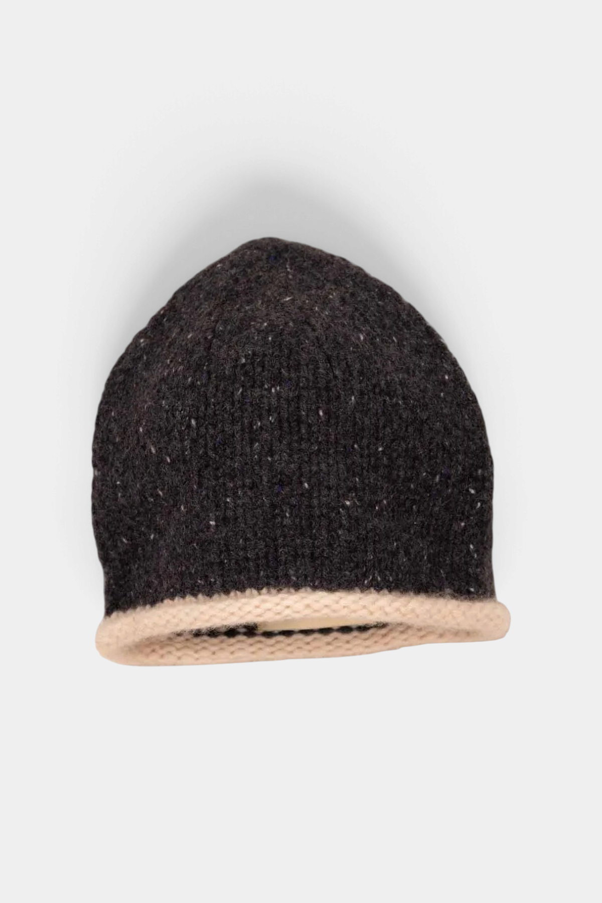 The Copper Shed hand-knitted organic cashmere beanie in dark charcoal with a contrasting cream rolled edge.
