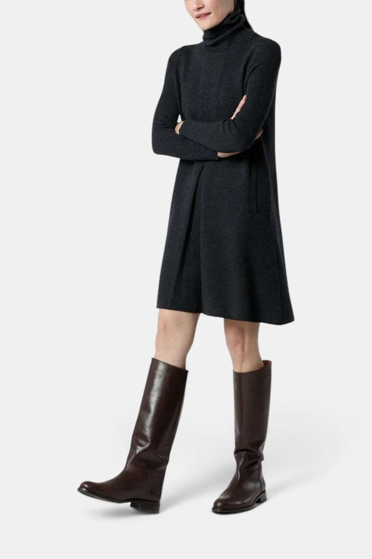 The Copper Shed Fosette charcoal grey merino wool sweater dress with funnel neck and front pleat worn with tall boots
