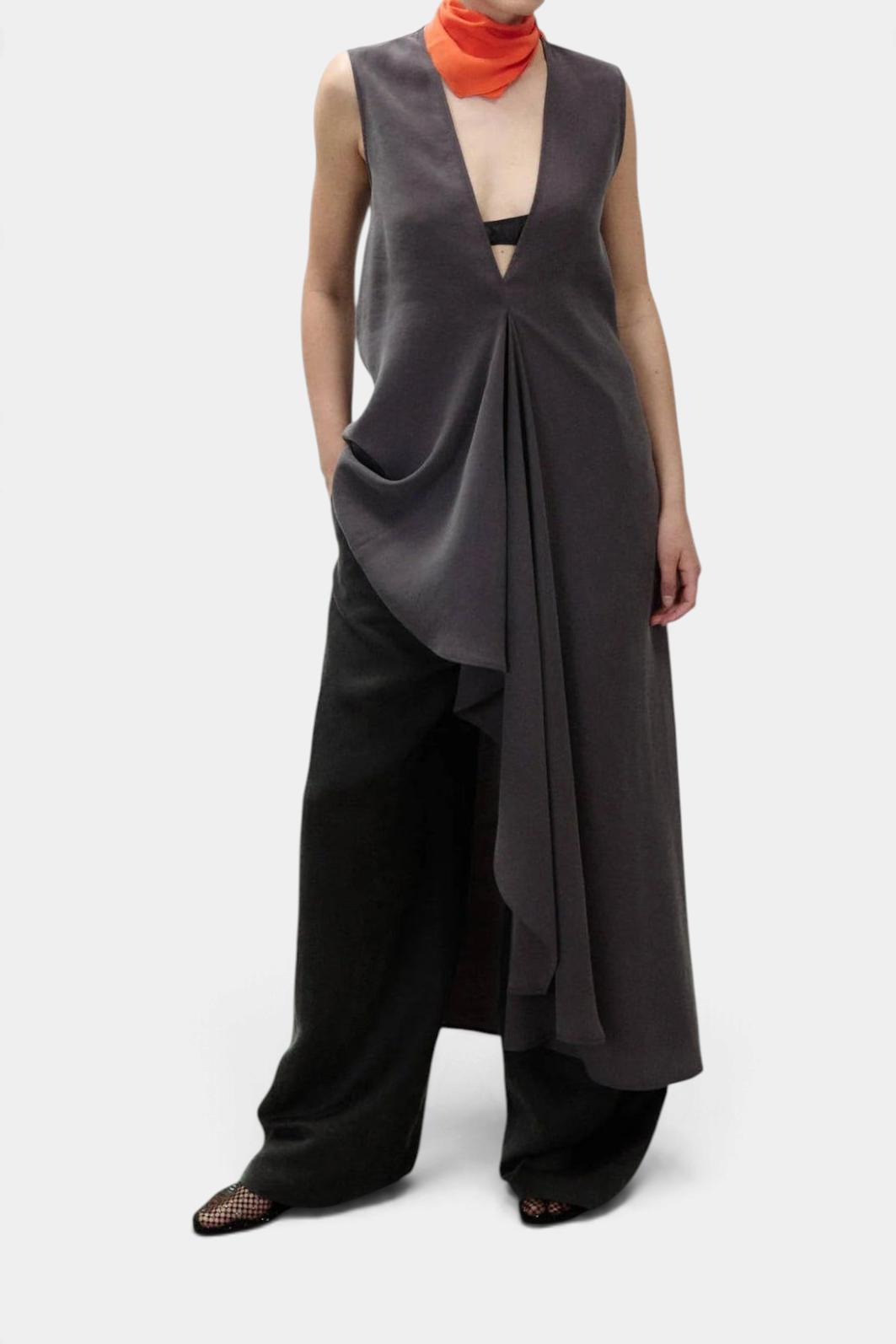 The Copper Shed sleeveless charcoal grey long dress with a deep V-neck, flared silhouette, and draped ruffle detail.