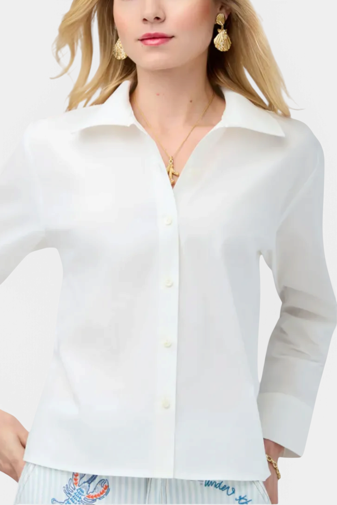 The Copper Shed Cher Blouse in pearl white stretch cotton with long sleeves, button front, and a structured collar.