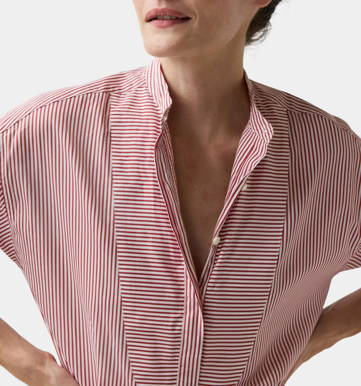 The Copper Shed Christiane bib-front tunic in red and white striped Italian cotton poplin with a mandarin collar.