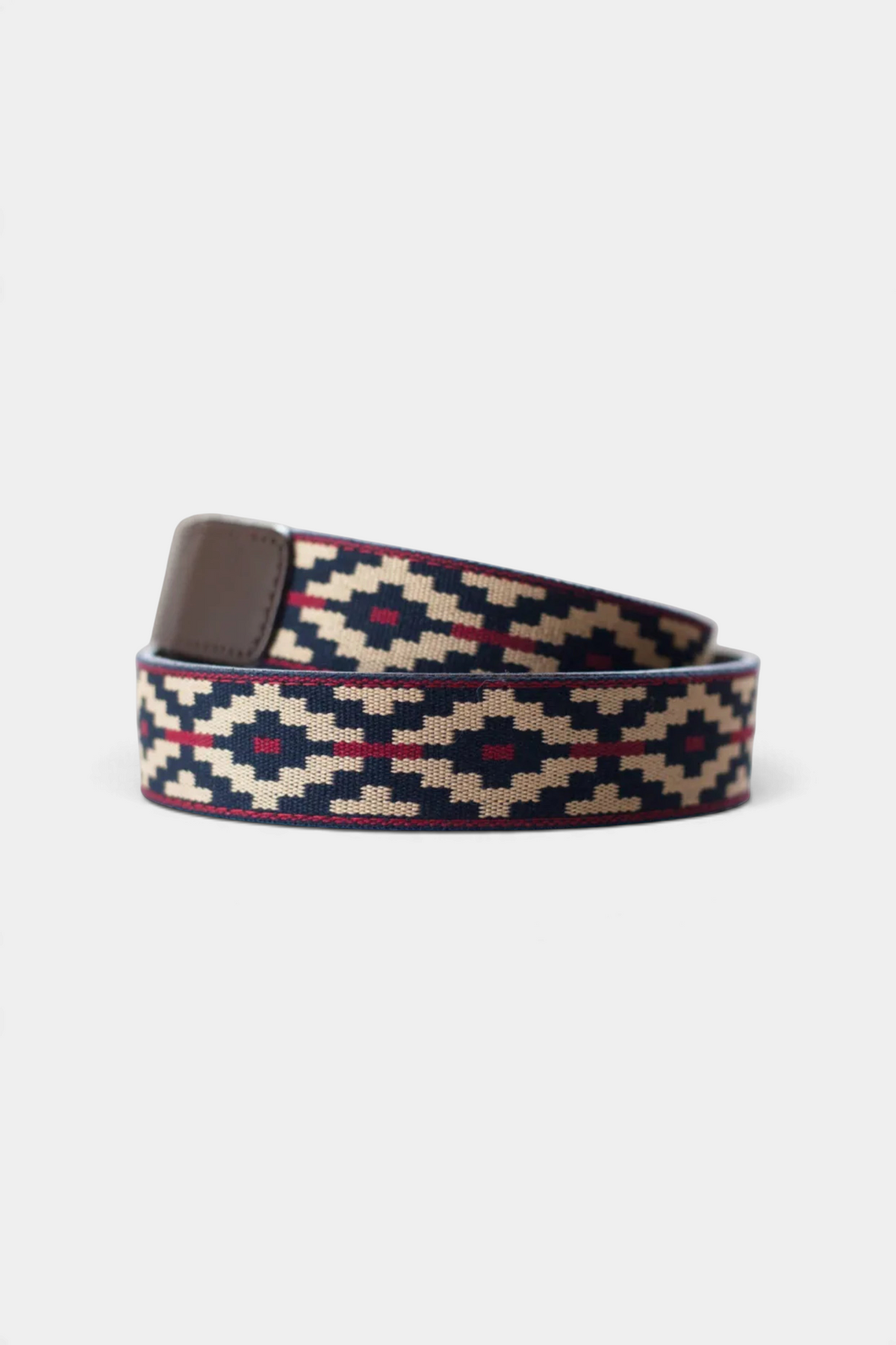 The Copper Shed Cinta Pampa polo belt featuring a navy, tan, and red woven cotton pattern with leather accents.