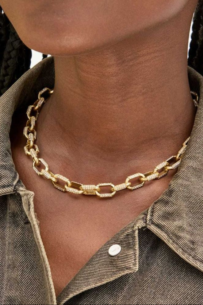 The Copper Shed Clare V Le Link gold chain necklace featuring pavé crystal accents worn around a model's neck.