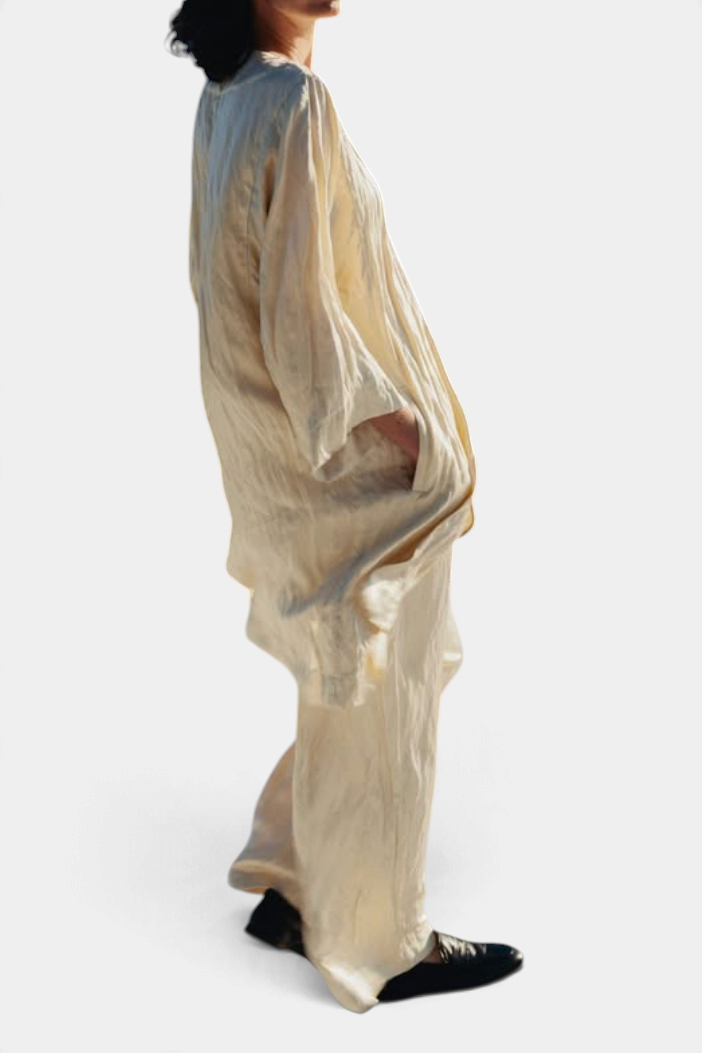 The Copper Shed crinkle viscose satin coat in champagne with metallic steel fibers and side pockets on a model