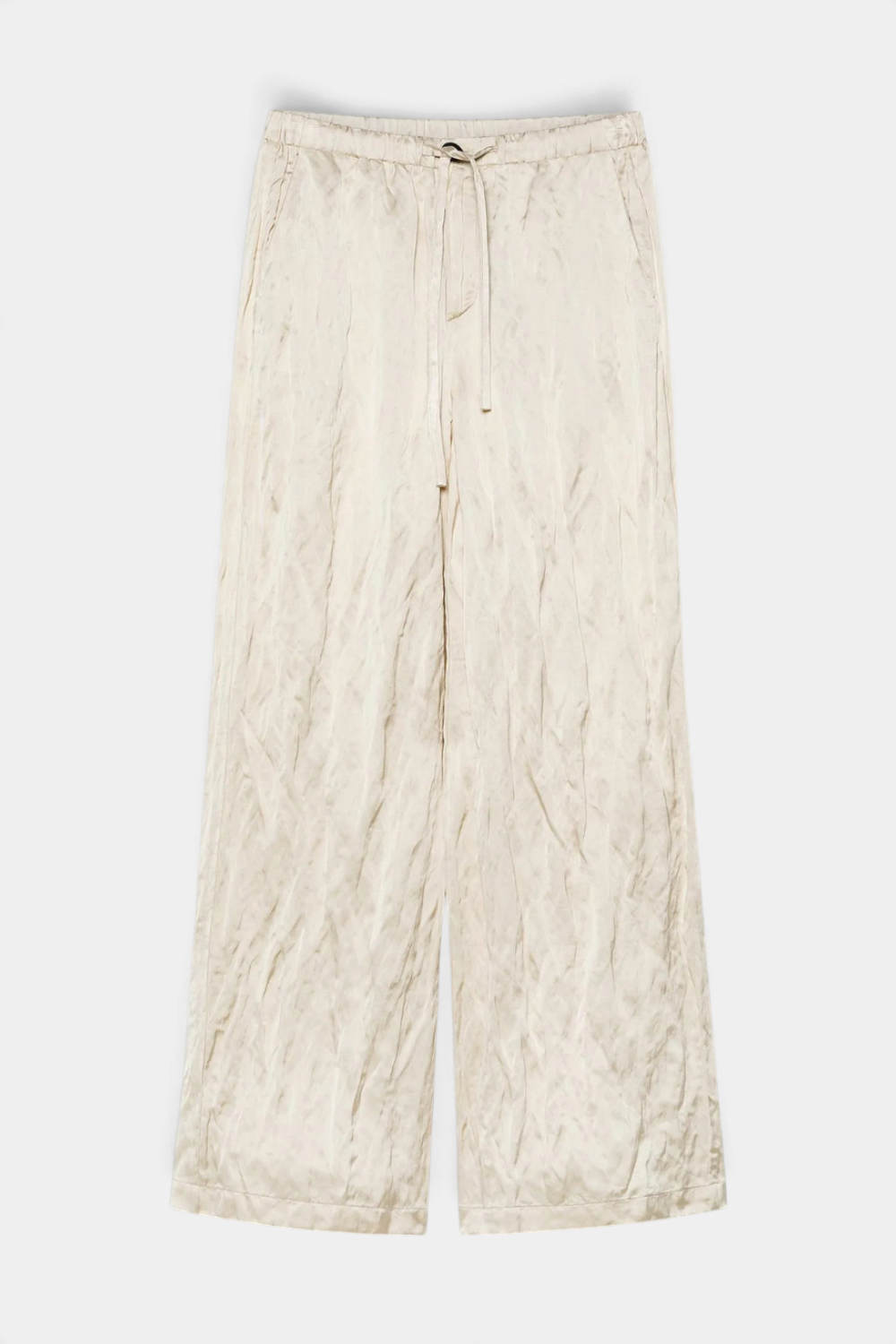 The Copper Shed crinkled viscose satin pants in a soft beige with an elastic drawstring waistband and wide-leg fit.