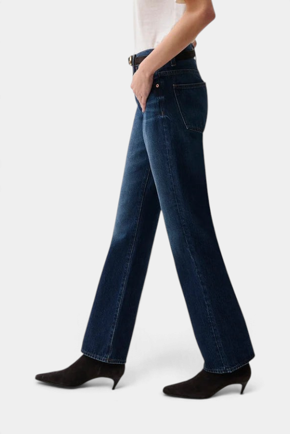The Copper Shed Dakota high rise bootcut jeans in dark indigo denim worn by a model with black kitten heel boots.