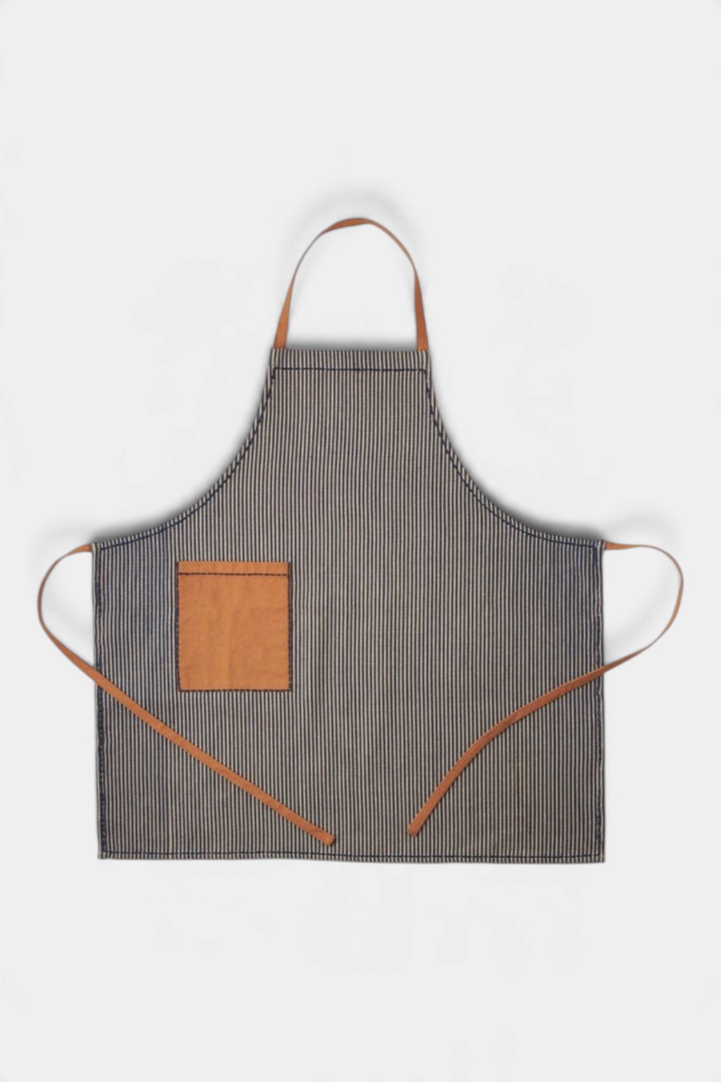 The Copper Shed Dalton blue striped apron in cotton jute with a leather pocket and adjustable leather straps.