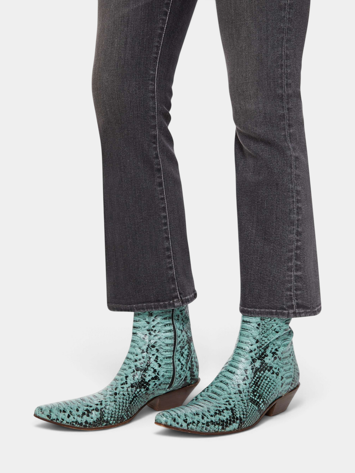 The Copper Shed The Hustler Ankle dark grey stretch denim flare jeans with a clean hem worn with teal snake boots.