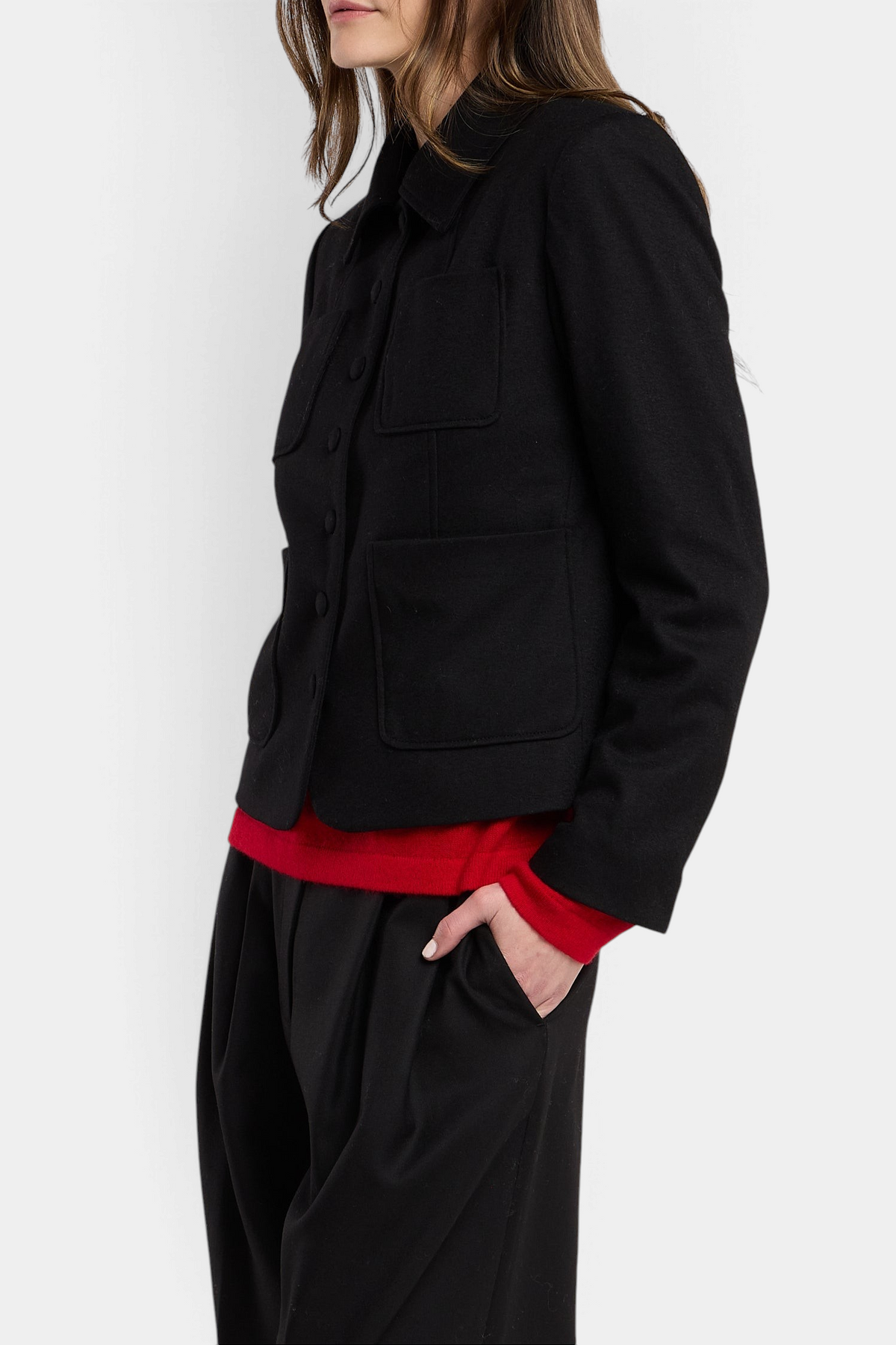 The Copper Shed Davina black wool-blend cropped jacket with button front and patch pockets worn over a red sweater