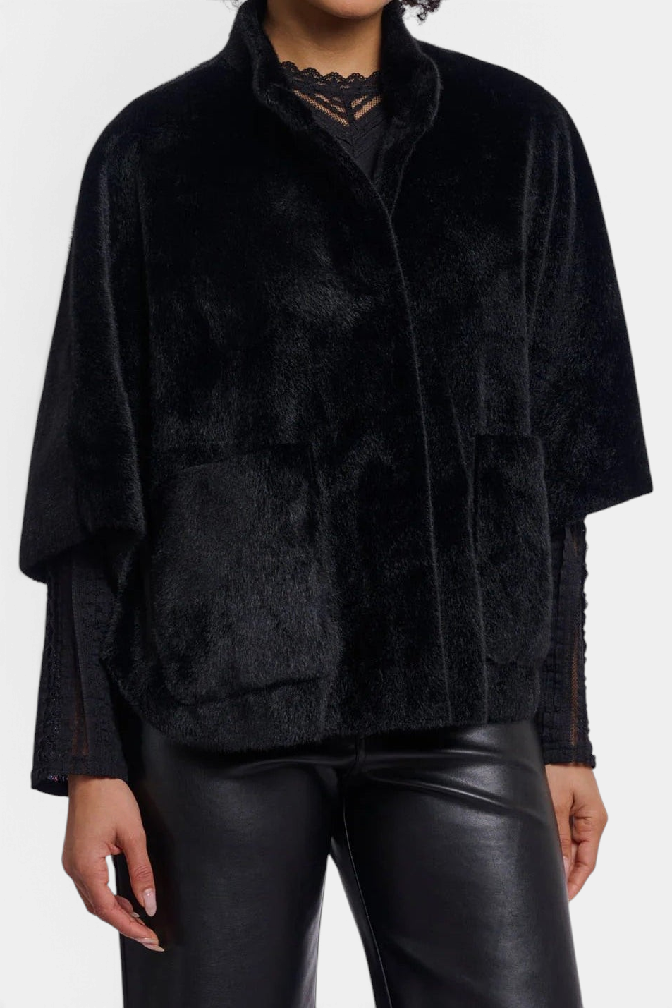 The Copper Shed Dewi black faux fur cape with short sleeves, front patch pockets, and button closure.