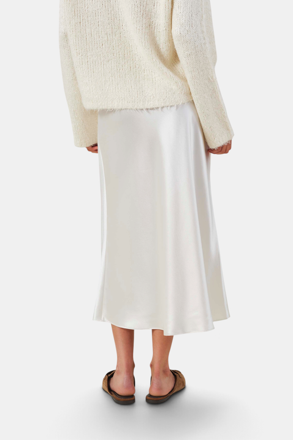 The Copper Shed Ella skirt in white satin with a bias-cut silhouette and high-rise waist, shown from the back.