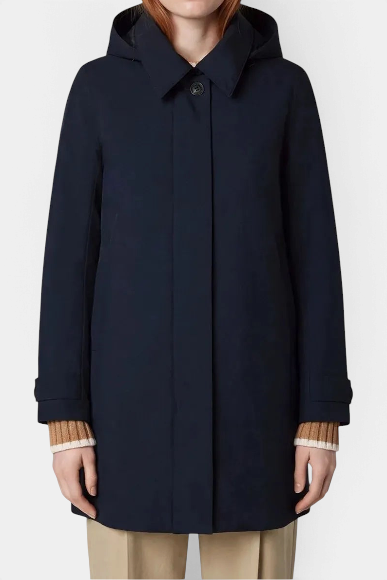 The Copper Shed Embie navy mid-length waterproof recycled polyester raincoat with a detachable hood and button front.