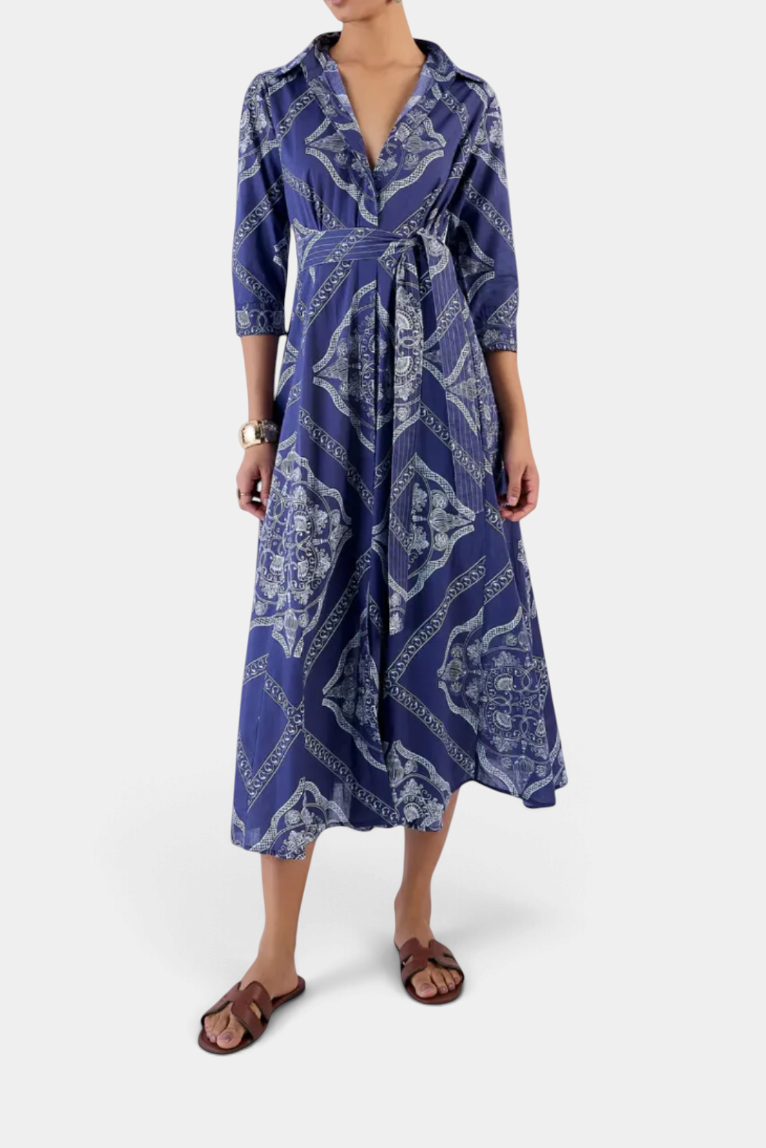 The Copper Shed Emily shirt dress in blue cotton voile with a patterned print, 3/4 sleeves, and a waist-tie belt.