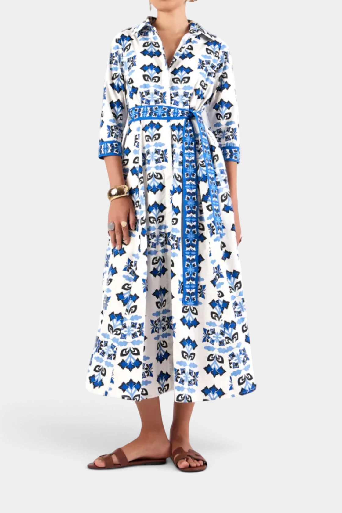 The Copper Shed Emily shirt dress in white cotton voile with a blue geometric print, 3/4 sleeves, and waist belt.