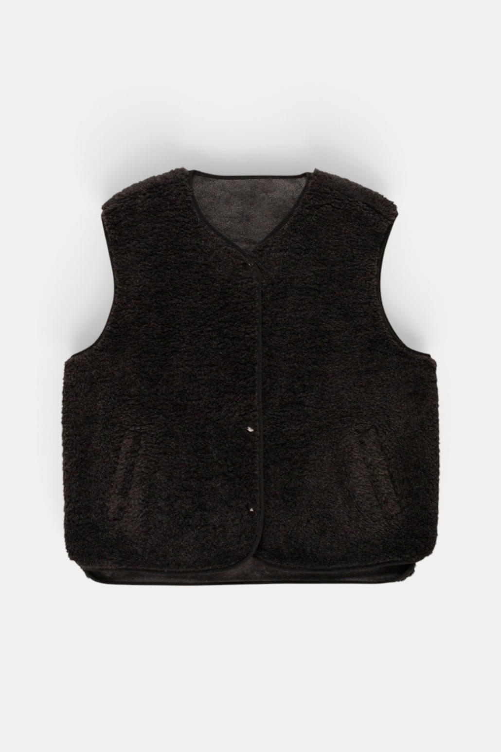 The Copper Shed dark brown faux sheepskin gilet with a popper fastening and front slip pockets.